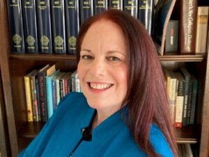 Headshot of Maureen Sherbondy in front of a bookcase